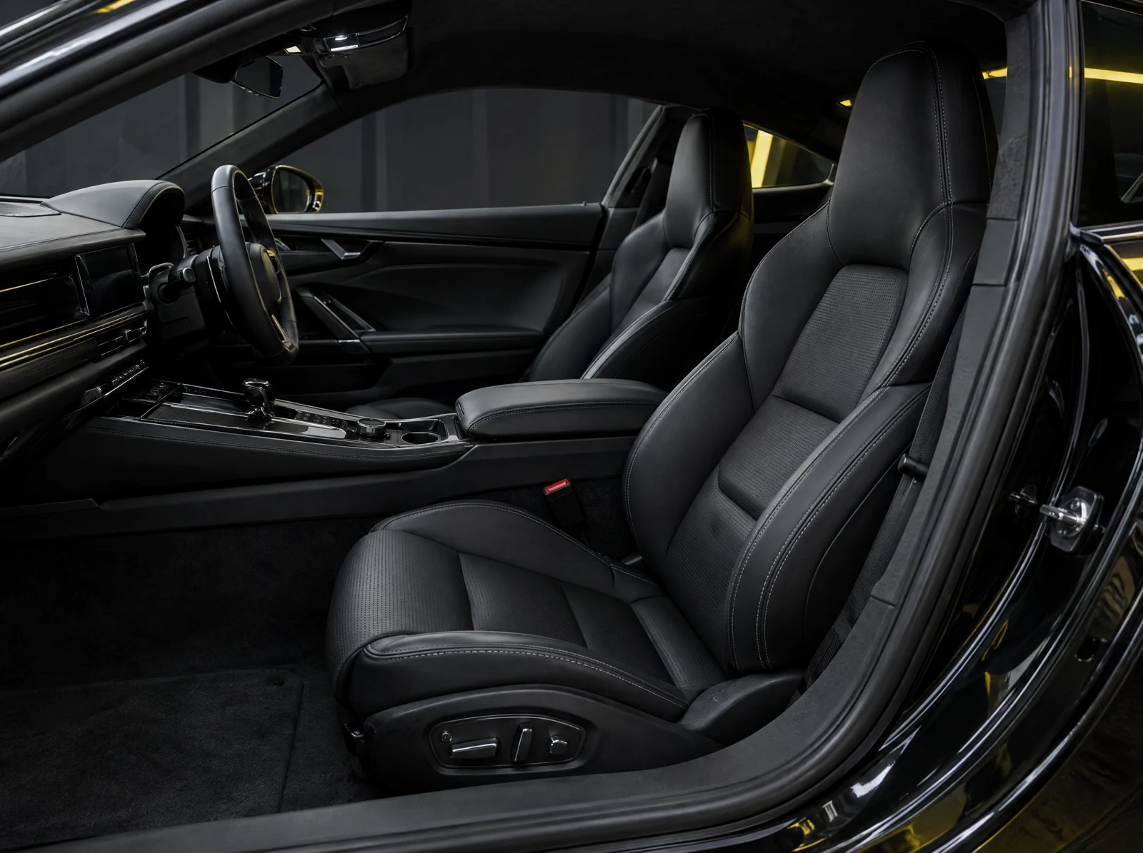 Refined dark vehicle interior with carefully finished surfaces.
